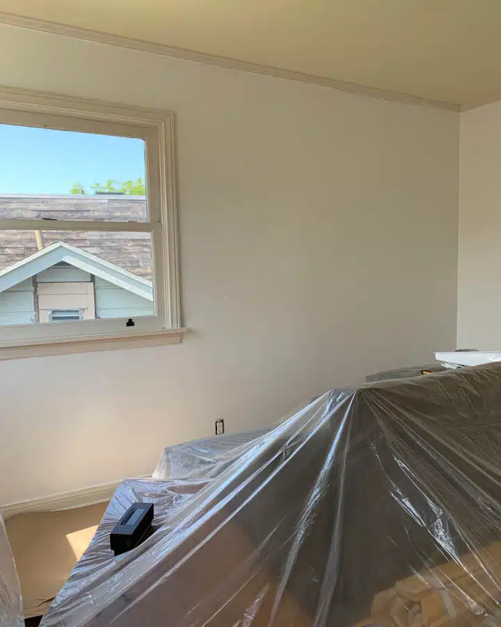 A bedroom with a bed and a window