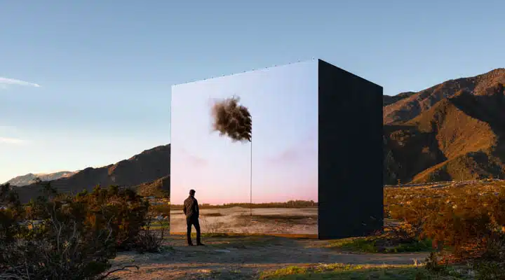 A person standing in front of a mountain
