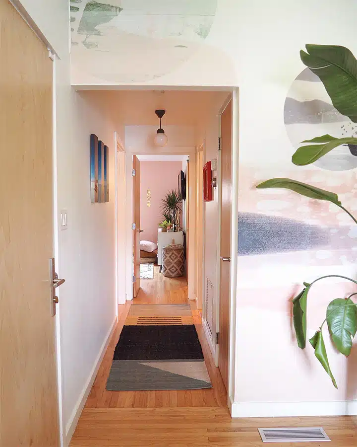 A cat sitting on top of a wooden door