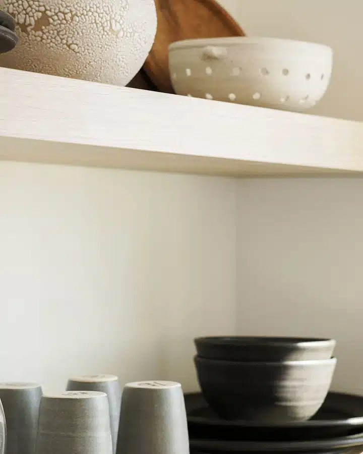 A bowl filled with furniture and vase on a table