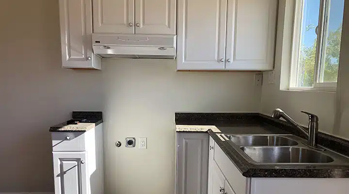 A kitchen with a sink and a window