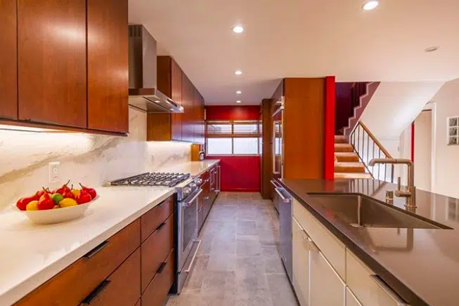 A modern kitchen with stainless steel appliances and wooden cabinets