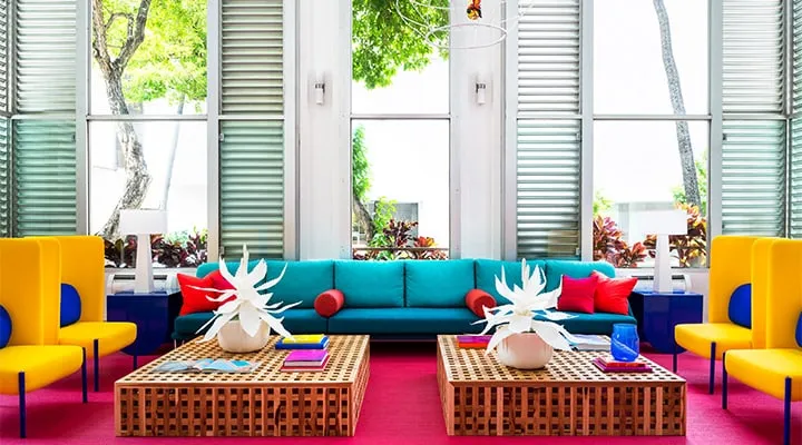 A living room filled with furniture and vase of flowers on a table