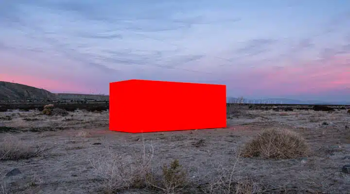 A sign on a dirt field