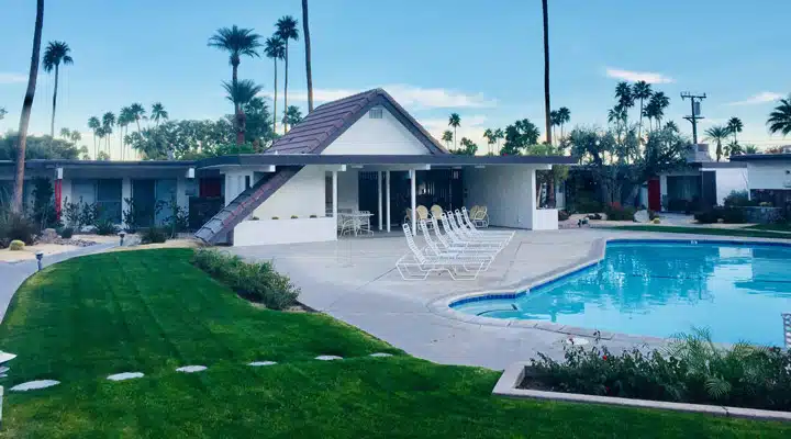 A house with a pool outside of a building