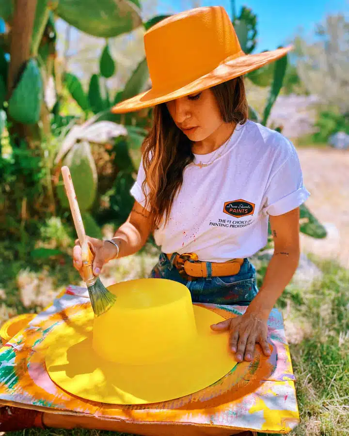 A person sitting at a table with a birthday hat