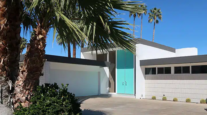 A palm tree in front of a building