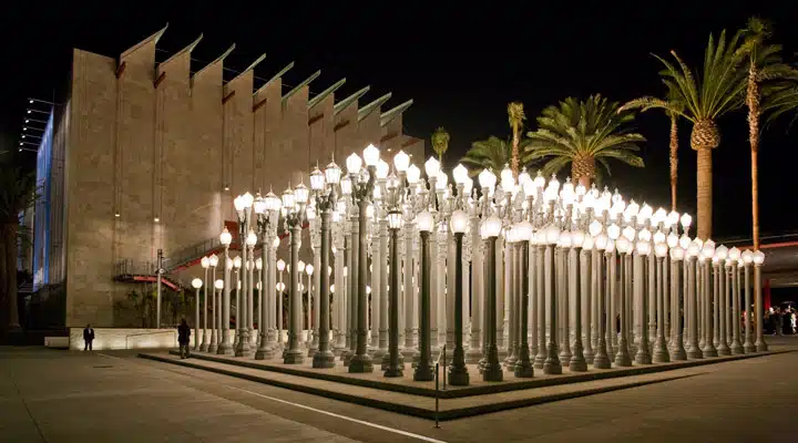 A row of tall buildings with Los Angeles County Museum of Art in the background