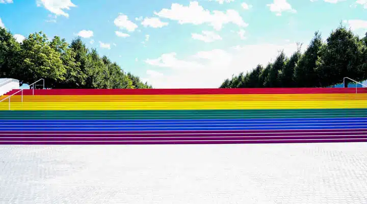A colorful train sits on the beach