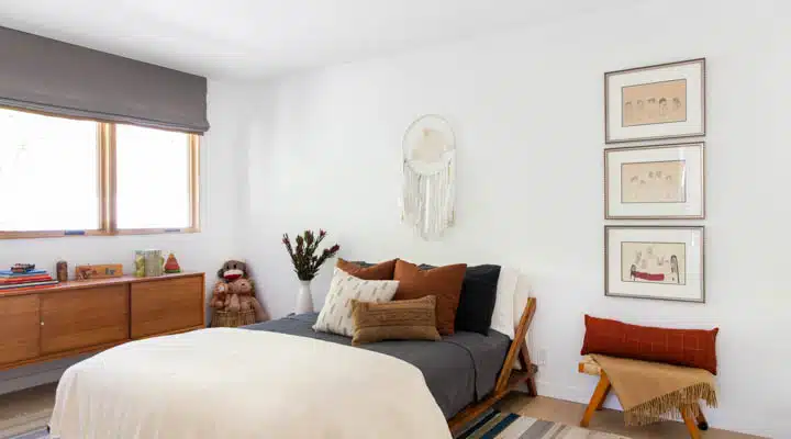 A bedroom with a bed and window in a room