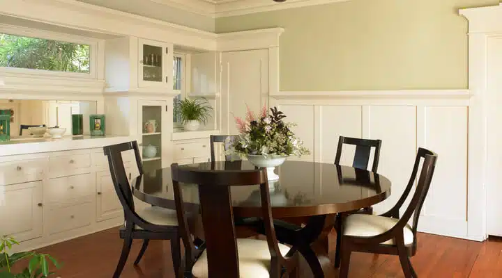 A dining room table in front of a window