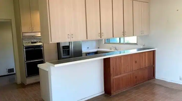 A kitchen with stainless steel appliances and wooden cabinets