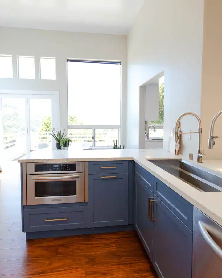 A large kitchen with stainless steel appliances and wooden cabinets