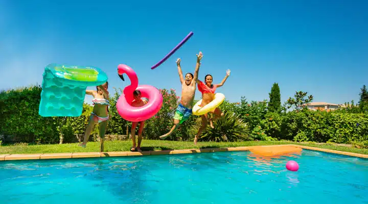 A group of people swimming in a pool of water