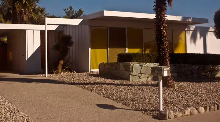 A person standing in front of a house