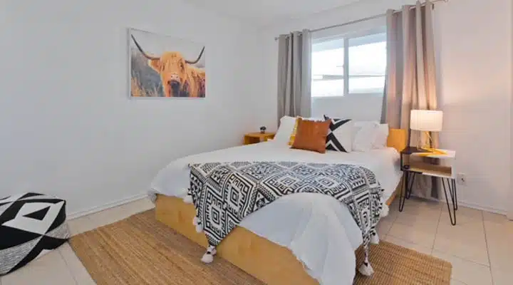 A bedroom with a bed and window in a room