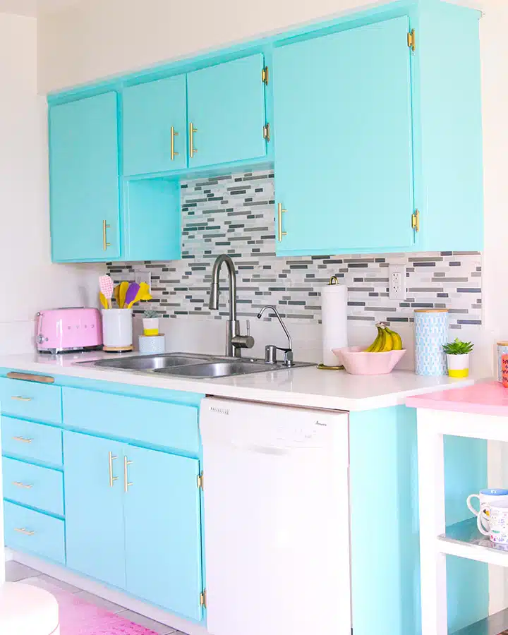 A kitchen with a sink and a refrigerator