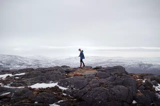 A man standing on a rock in the snow