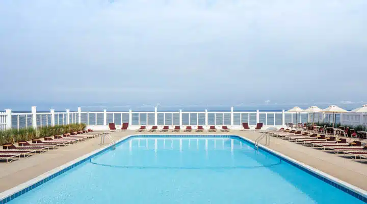 A pool next to a body of water