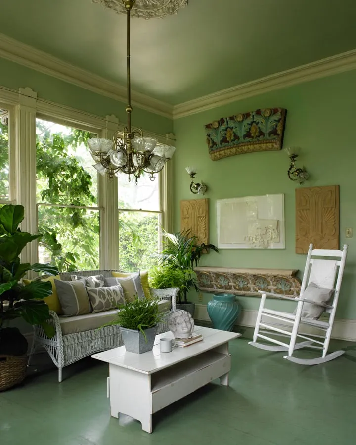 A living room filled with furniture and vase of flowers on a table