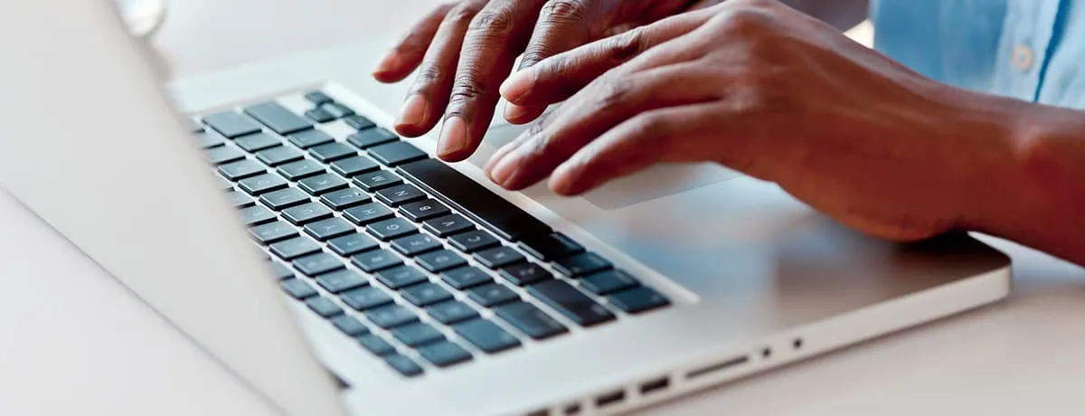 A laptop computer sitting on top of a keyboard