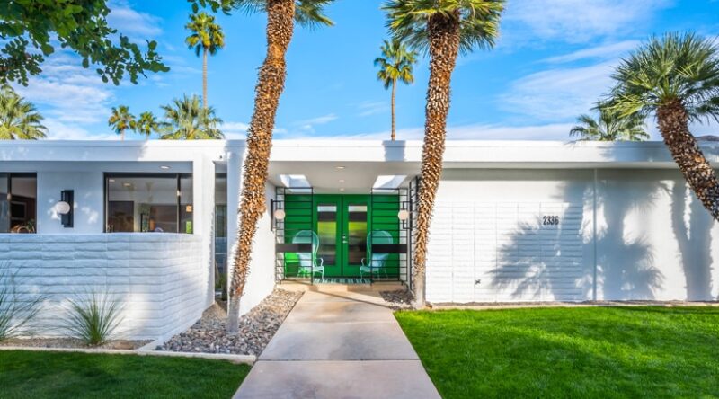 A palm tree in front of a building