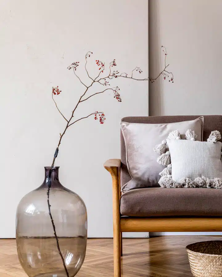 A living room filled with furniture and vase on a table