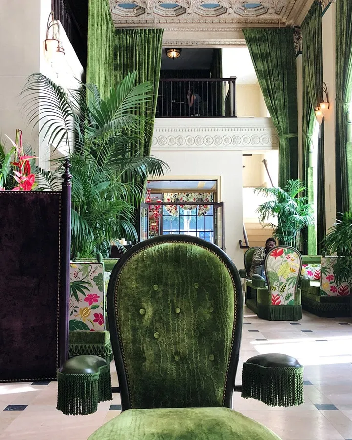 A room filled with furniture and vase of flowers on a table