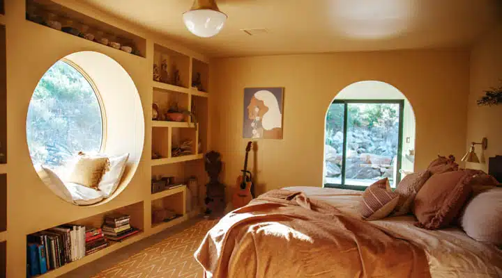 A view of a living room with a bed and looking at the camera