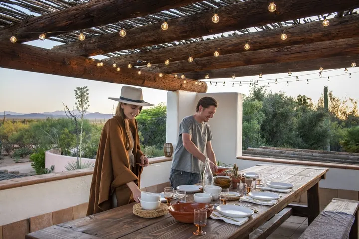 A man standing on top of a wooden table