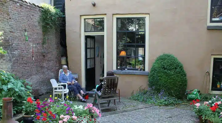 A vase of flowers on a brick building