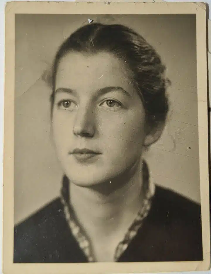 A woman standing in front of a mirror posing for the camera