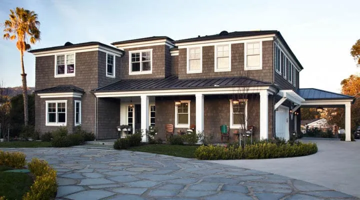 A large brick building with grass in front of a house