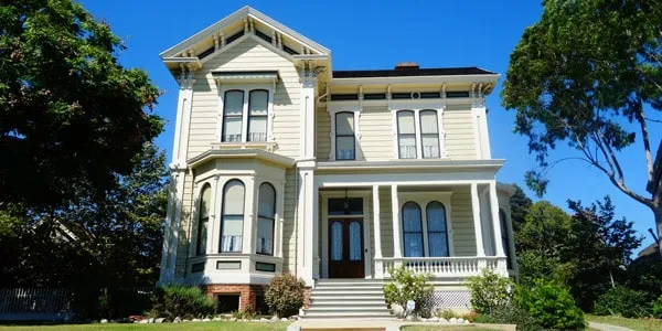 A house with bushes in front of a building