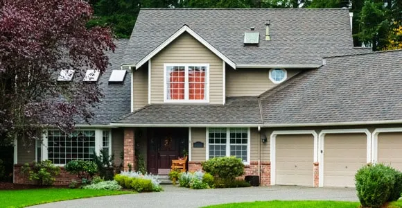 A small house in front of a brick building