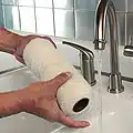 A man standing next to a sink