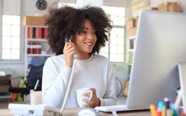 A person sitting at a table using a laptop