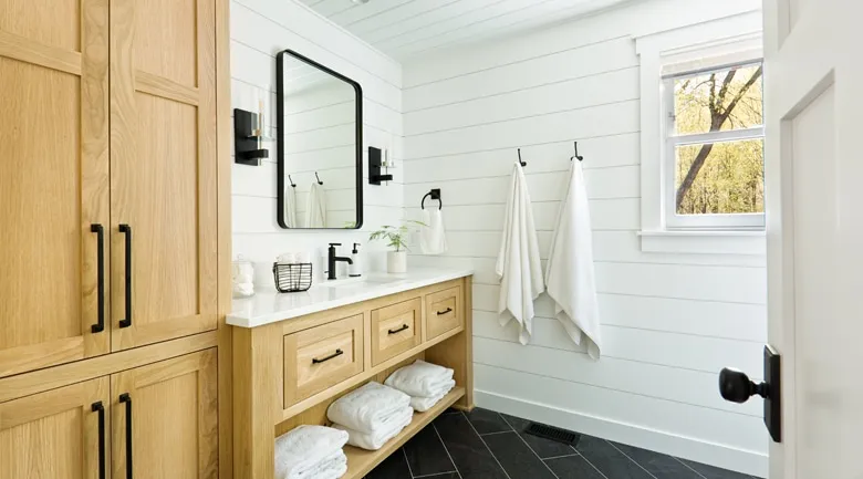 A kitchen with a sink and a mirror