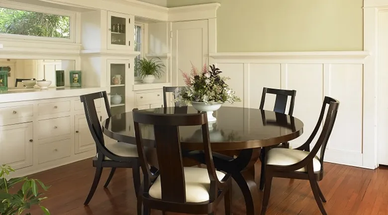 A dining room table in front of a window