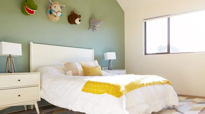 A bedroom with a bed and desk in a hotel room