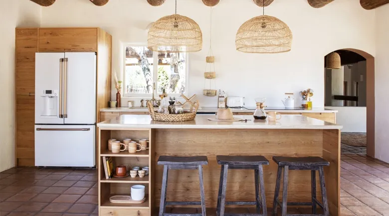 A kitchen with wooden cabinets and a table in a room