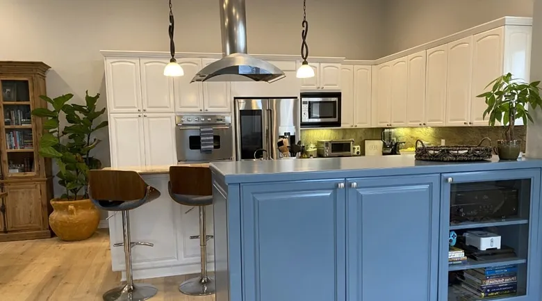 A kitchen with a table in a room