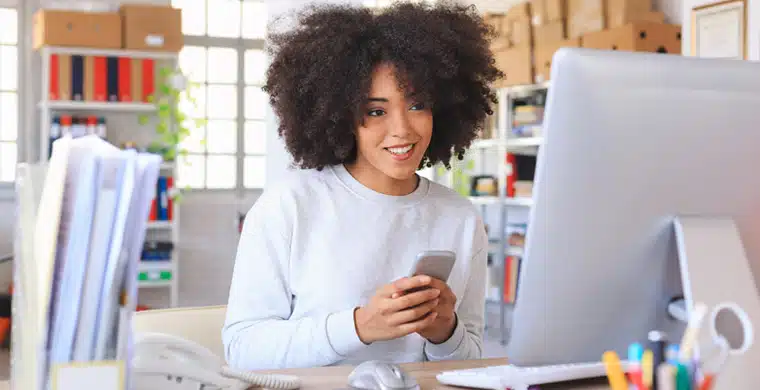 A person sitting at a table using a laptop