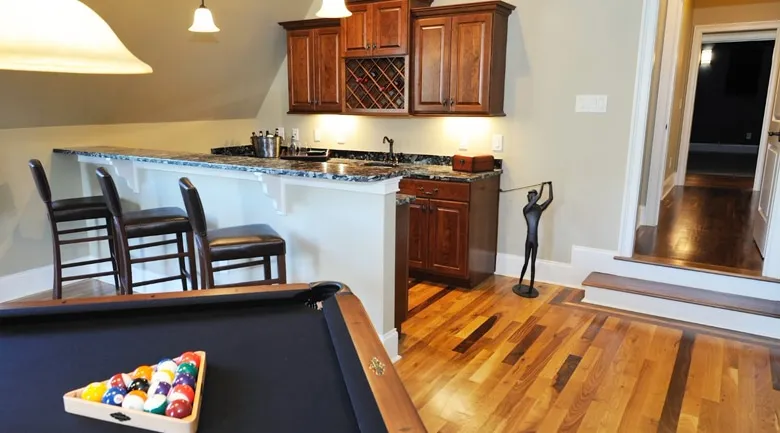 A kitchen with wooden cabinets and a dining room table