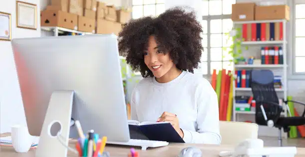 A person sitting at a table using a laptop computer