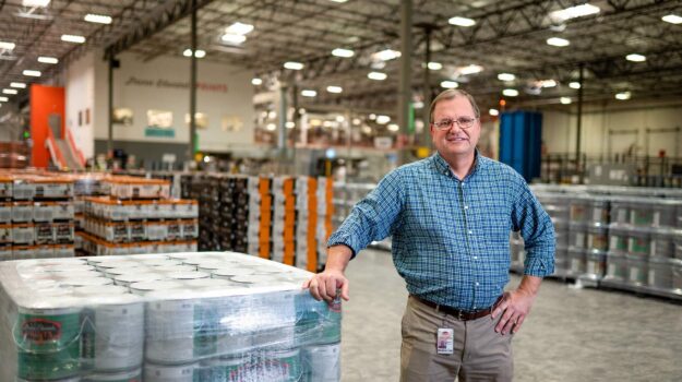 A man standing in front of a can