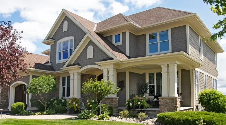 A house with bushes in front of a building