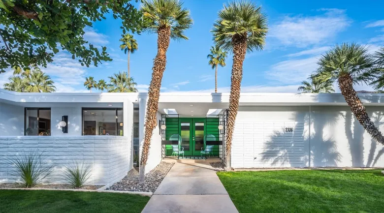 A palm tree in front of a building