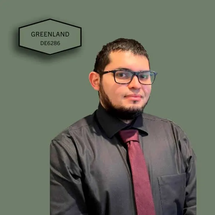 A man wearing glasses posing for the camera