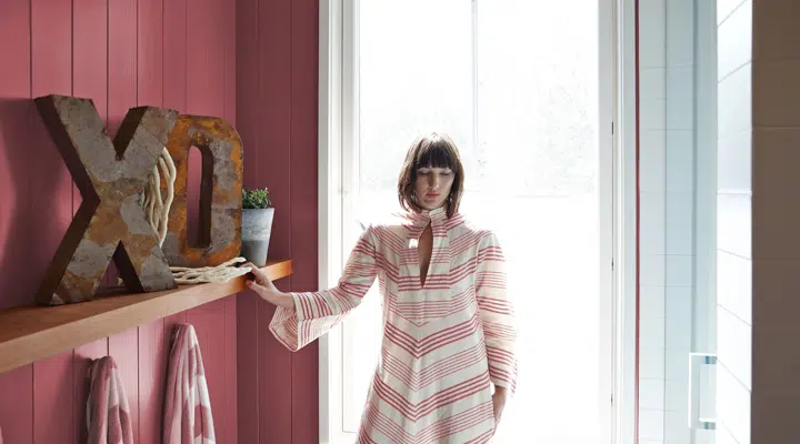 A person standing in front of a window